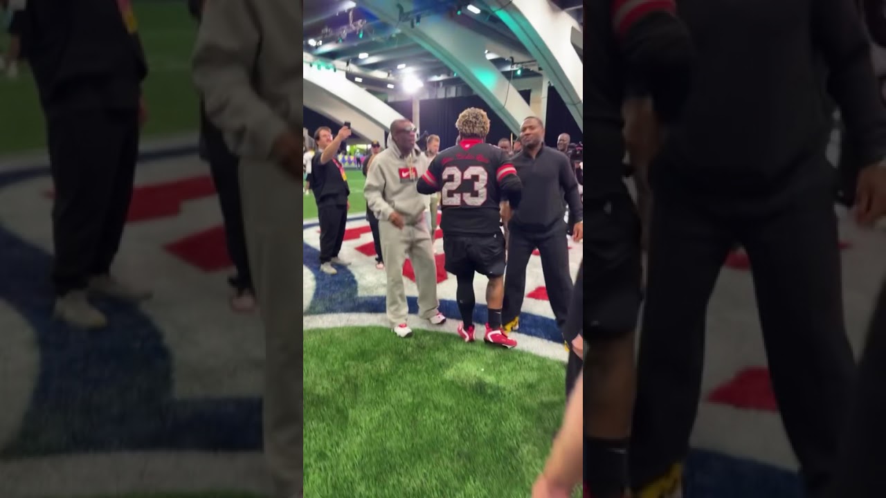 Deion Sanders helping Druski up at The NFL Flag football Game Deion Sanders helping Druski up at The NFL Flag football Game